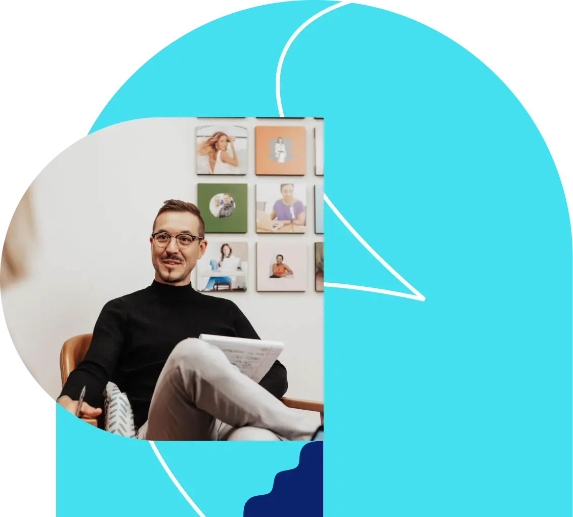 photo of a male leadpages employee with a wall of leadpages customer images behind him